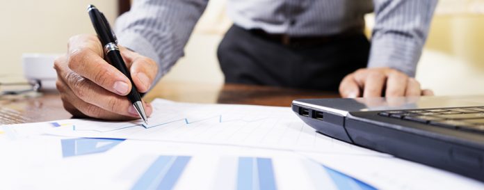Business people analyzing investment charts in meeting room, Accounting concept